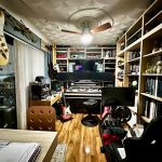 Home music studio with instruments and recording equipment.