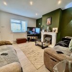Cosy living room with television and fireplace.