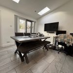 Modern office with table, chair, and TV